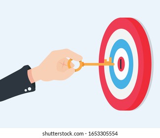 Flat hand are holding the key to unlock the center of the target. the key to success.