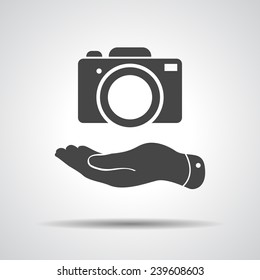 flat hand shows the photo camera icon - vector illustration