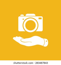 flat hand shows the photo camera icon - vector illustration