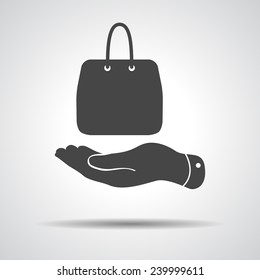 flat hand shows the shopping bag icon - vector illustration