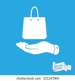 flat hand shows the shopping bag icon - vector illustration