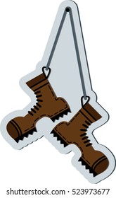 Flat hiking boots hanging on a string.