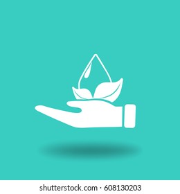 Flat icon. A drop of water on a leaf. On the palm.