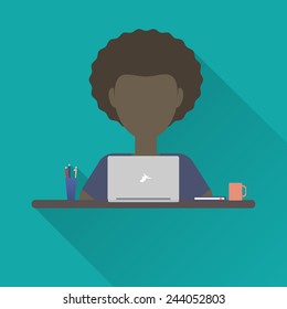 Flat icon man. A man working at a laptop sitting at his desk