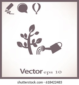 The flat icon. Watering plants. Water pouring from a watering can on the plant.