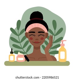 Flat illustration african american woman with towel on head takes care of skin. Cleanser, facial cerum and cream elements. Vector illustration