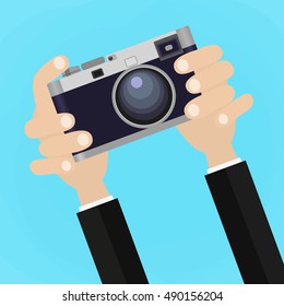 Flat illustration of Retro photo camera with hand holding it. illustration of a hand holding Vintage camera for your design