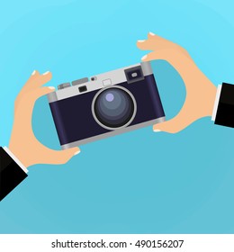 Flat illustration of Retro photo camera with hand holding it. illustration of a hand holding Vintage camera for your design