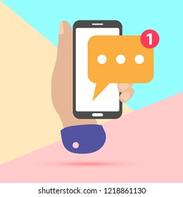 flat lay modern minimal hand holding mobile phone with new chat message notification with shadow on pastel colored blue and pink background. Text new messaging minimalism design concept.