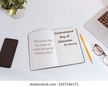 Flat lay with a notebook, phone, and pencil, celebrating International Day of Education with motivational quotes.