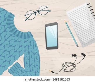 Flat lay with the notebook, smartphone, wool sweater, pencil and earphones. Flat vector illustration.