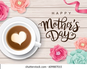 Flat lay style mother's day greeting card with coffee cup and flowers on wooden table.