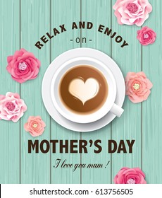 Flat lay style mother`s day greeting card with coffee cup and flowers on wooden table.