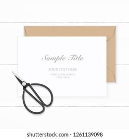Flat lay top view elegant white composition paper kraft envelope and vintage metal scissors on wooden background.