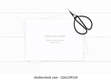 Flat lay top view elegant white composition paper and vintage metal scissors on wooden background.