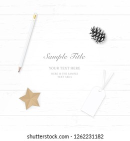 Flat lay top view elegant white Christmas composition paper pine cone pencil tag and star shape craft on wooden background.