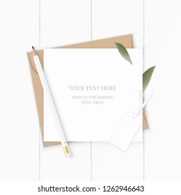 Flat lay top view elegant white composition letter kraft paper envelope nature leaf pencil and tag on wooden background.