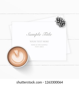 Flat lay top view elegant white Christmas composition paper pine cone and coffee on wooden background.