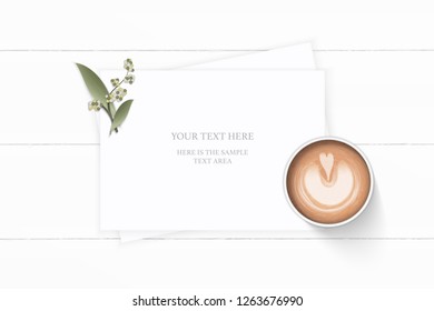 Flat lay top view elegant white composition paper plant leaf flower and coffee on wooden background.