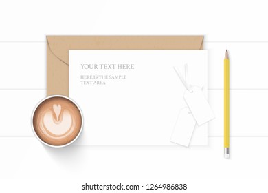 Flat lay top view elegant white composition letter kraft paper envelope yellow pencil coffee and tags on wooden background.