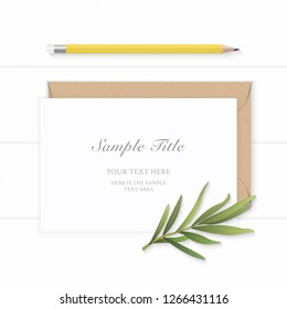 Flat lay top view elegant white composition paper kraft envelope tarragon leaf and yellow pencil on wooden background.