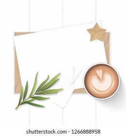 Flat lay top view elegant white composition paper kraft envelope tag star craft tarragon leaf and coffee on wooden background.