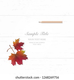 Flat lay top view elegant white composition paper autumn red maple leaf and pencil on wooden background.