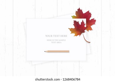 Flat lay top view elegant white composition paper autumn red maple leaf and pencil on wooden background.