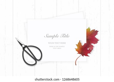Flat lay top view elegant white composition paper autumn red maple leaf and vintage metal scissors on wooden background.
