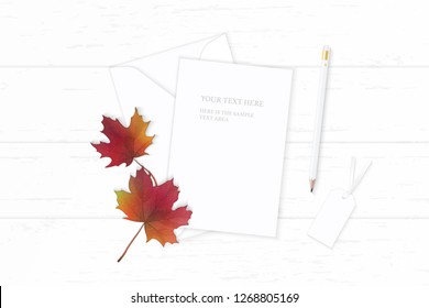 Flat lay top view elegant white composition letter paper envelope pencil tag autumn maple leaf on wooden background.