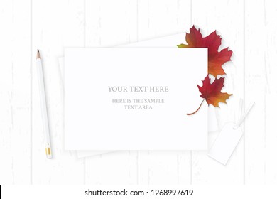 Flat lay top view elegant white composition paper pencil tag and autumn nature maple leaf on wooden background.