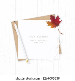 Flat lay top view elegant white composition letter kraft paper envelope nature autumn maple leaf pencil and tag on wooden background.