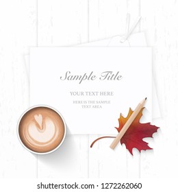 Flat lay top view elegant white Christmas composition paper pine cone pencil autumn maple leaf tag and coffee on wooden background.