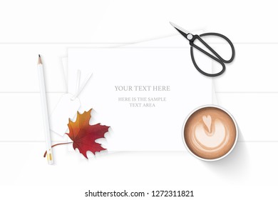 Flat lay top view elegant white composition paper pencil tag coffee autumn maple leaf and vintage metal scissors on wooden background.