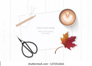 Flat lay top view elegant white composition paper pencil autumn maple leaf coffee and vintage metal scissors on wooden background.