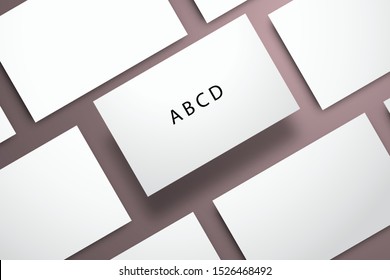 Flat layout with rows of white blank cards close-up. The central card is elevated above the colored surface. Mockup for design with letters ABCD