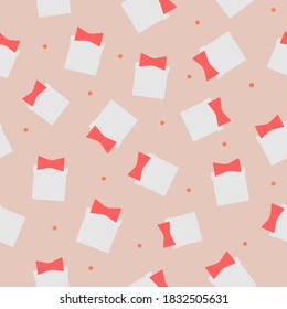 Flat light gift boxes with pale red bows and orange dots on light pink background. Seamless Christmas stylized pattern. Suitable for wrapping paper, textile, wallpaper.