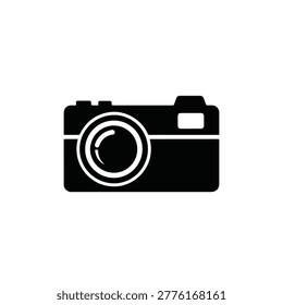 A flat, monochrome icon depicting a classic camera. It features a lens, viewfinder, and basic rectangular body, representing photography and image capture.