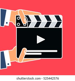 Flat movie clapperboard symbol in human hands. Stylish blank movie clapperboard elements. Film icon. Video sign. Vector