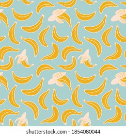 Flat seamless pattern with yellow bananas. Fruit vector pattern on light blue background. Perfect for fabric, clothes, wallpaper, wrap paper
