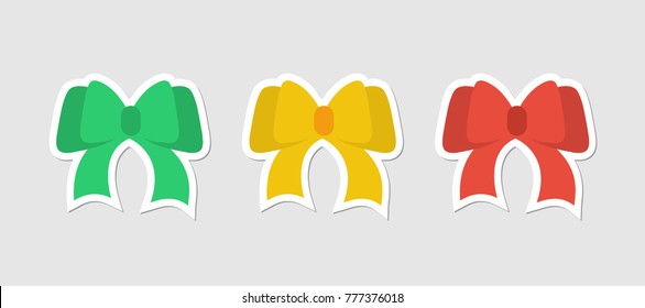 Flat stickers festive bows. Bows red, green and yellow color on gray background