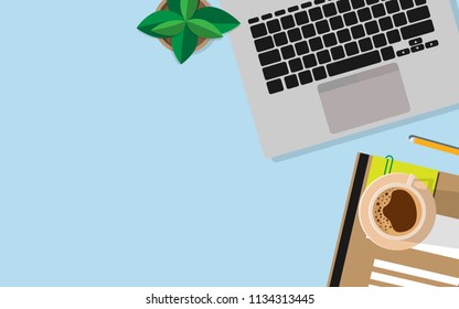 Flat view top down to the working space table with laptop,coffee,pencil,notebook and small tree with copy space for your text