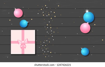 Flatlay. Christmas balls with gift on wooden table