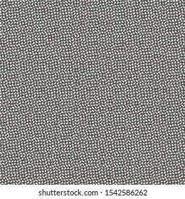 Flecked background, a mixture of small spots, white and dark brown, which can be compared with the texture of a rough woolen fabric.