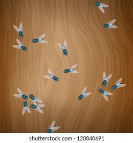 Flies on wooden table