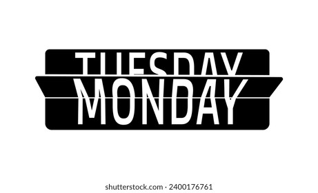 A flip clock showing the change of days of the week from Monday to Tuesday