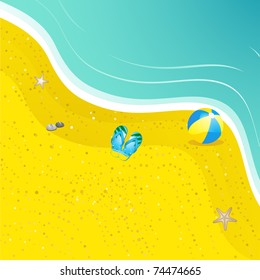 flip flops, beach ball and starfish on a golden beach