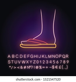 Flip flops neon light icon. Woman stylish footwear design. Female beach shoes, modern summer season flats side view. Glowing sign with alphabet, numbers and symbols. Vector isolated illustration