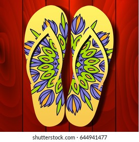 Flip flops on a wooden background, flip flops with mandala, slippers on the floor