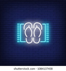 Flip-flops on carpet neon sign. Sandals on small blue carpet. Night bright advertisement. Vector illustration in neon style for trip and vacation